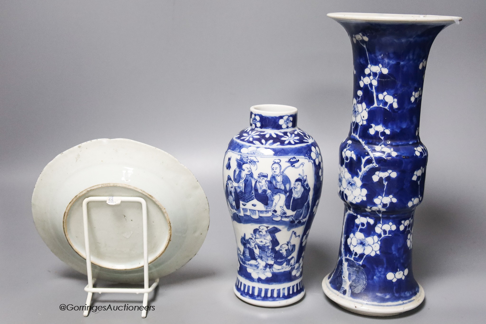 A Chinese blue and white gu vase, a baluster vase and a dish, tallest 26cm